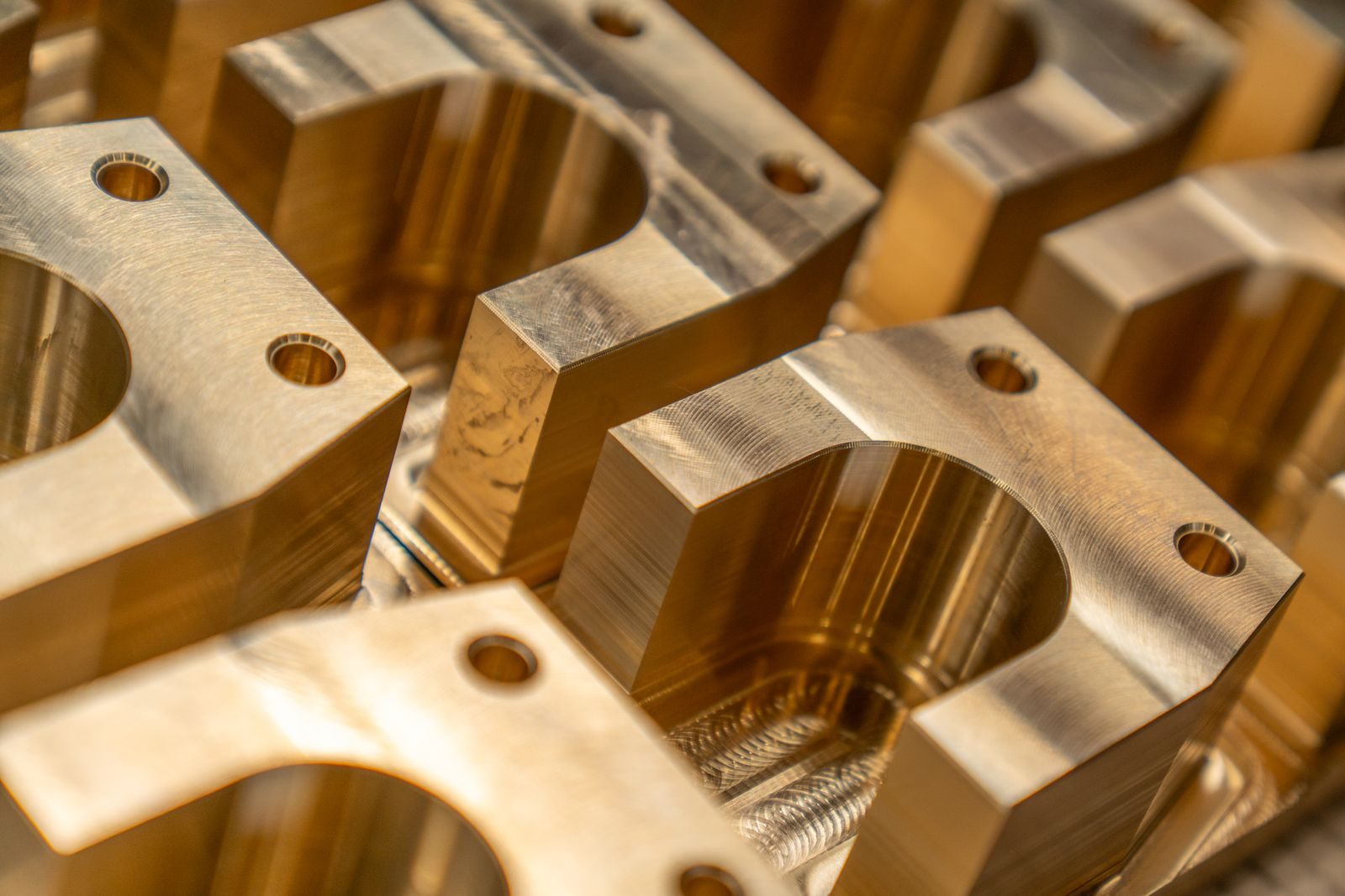 Machined prototype metal parts laid out on a workbench.