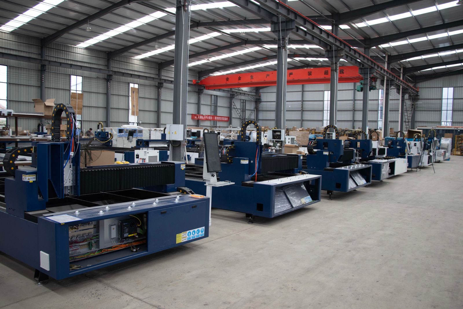 A machine shop floor with rows of machine tools.
