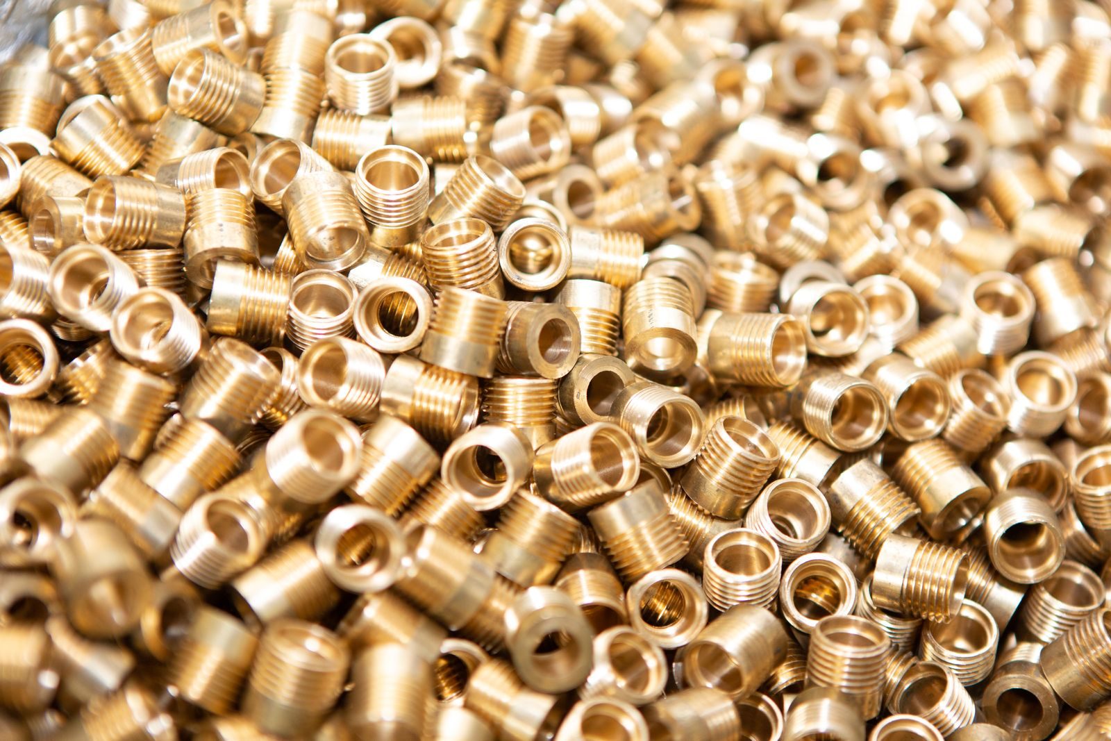 A batch of turned metal components.